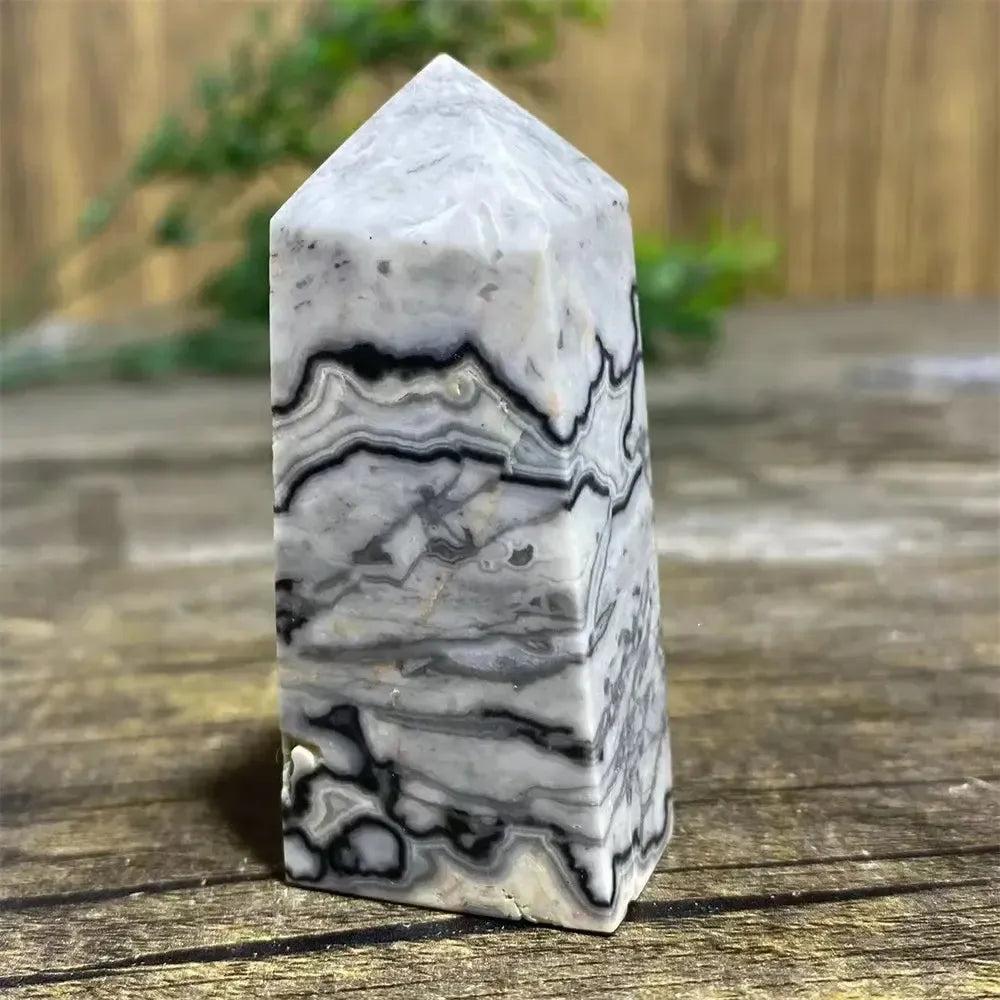 Picasso Stone Crystal Tower with bold black brushstrokes on a warm cream base, grounding Root Chakra stone.