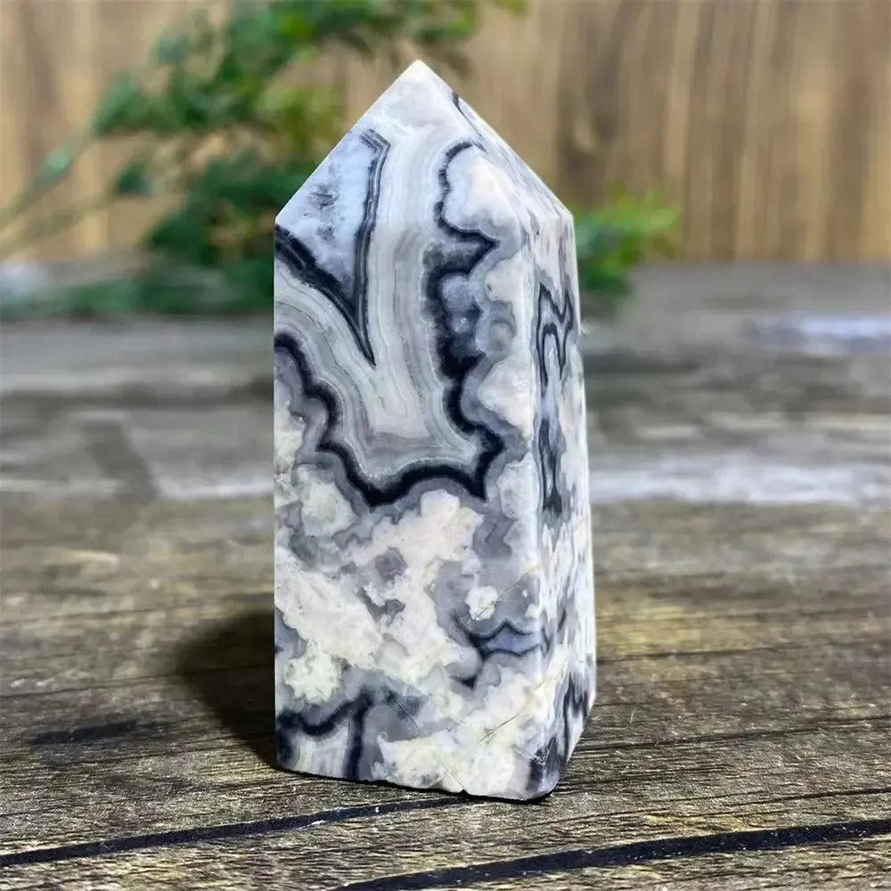 Picasso Stone Crystal Tower with bold black brushstrokes on warm cream, grounding Root Chakra stone.