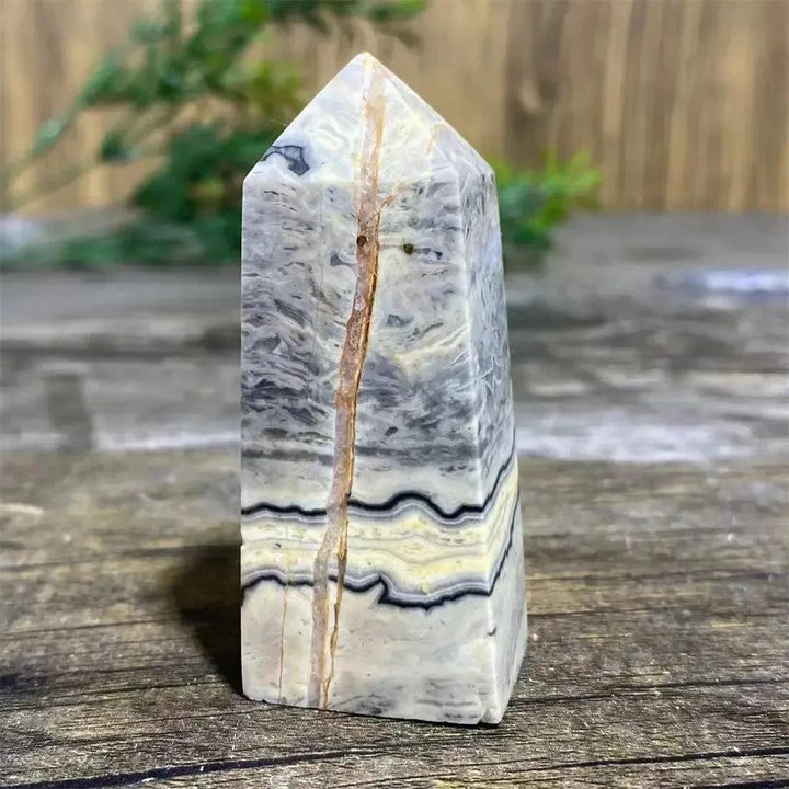 Picasso Stone Crystal Tower with bold black brushstrokes on warm cream, grounding Root Chakra stone.