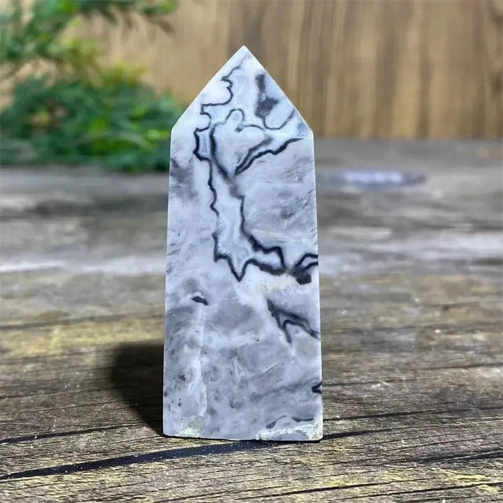 Picasso Stone Crystal Tower with bold black brushstrokes on warm cream, grounding Root Chakra stone.