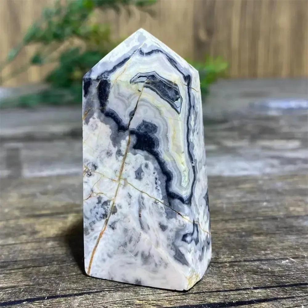 Picasso Stone Crystal Tower with bold black brushstrokes on warm cream, grounding Root Chakra stone.