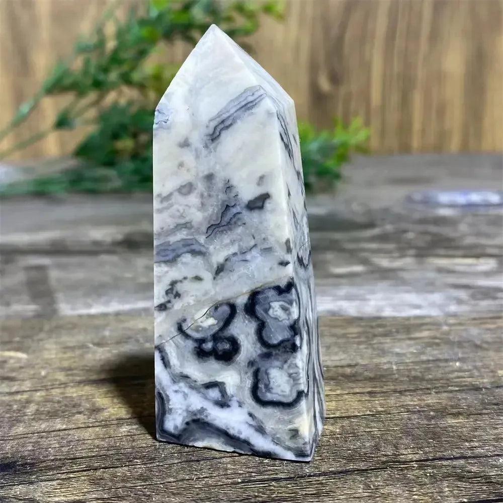 Picasso Stone Crystal Tower with bold black brushstrokes on warm cream, grounding Root Chakra stone.