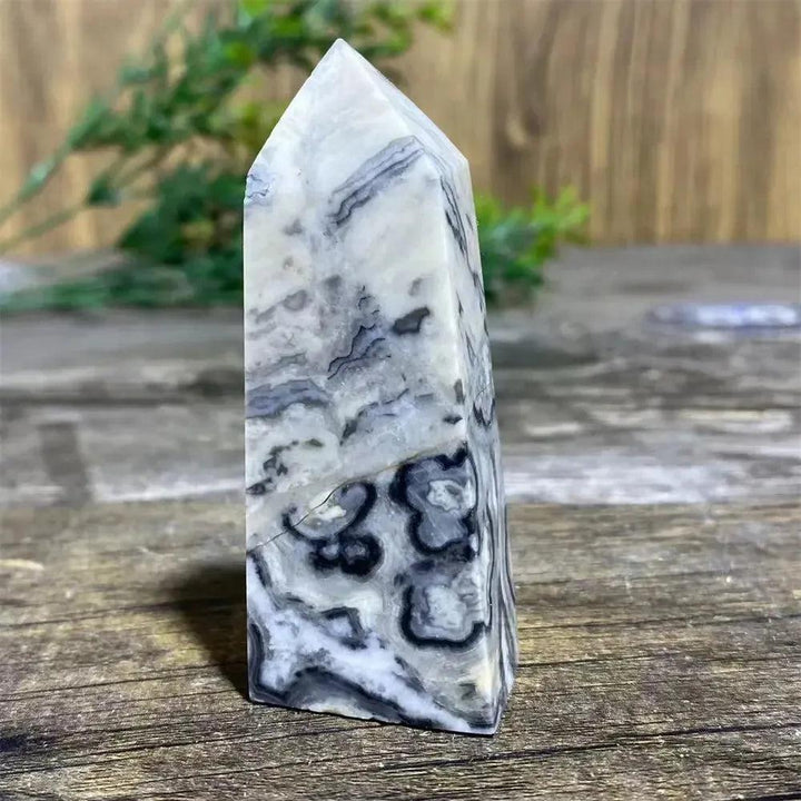 Picasso Stone Crystal Tower with bold black brushstrokes on warm cream, grounding Root Chakra stone.