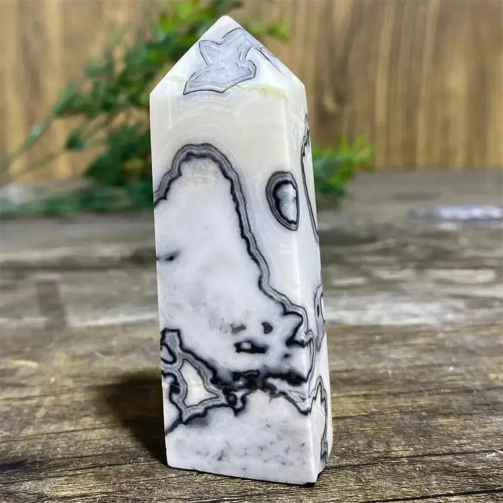 Picasso Stone Crystal Tower: grounding root chakra stone with bold black brushstrokes on warm cream, hand-polished.