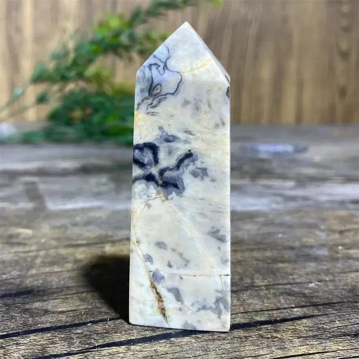 Picasso Stone Crystal Tower with bold black brushstrokes on warm cream, a grounding Root Chakra stone.