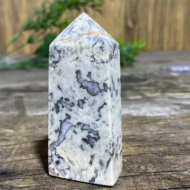 Picasso Stone Crystal Tower with bold black brushstrokes on warm cream, grounding Root Chakra stone.