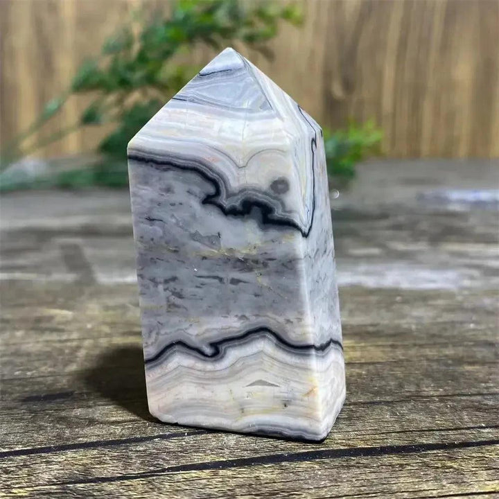 Picasso Stone Crystal Tower with bold black brushstrokes on warm cream, grounding Root Chakra energy.