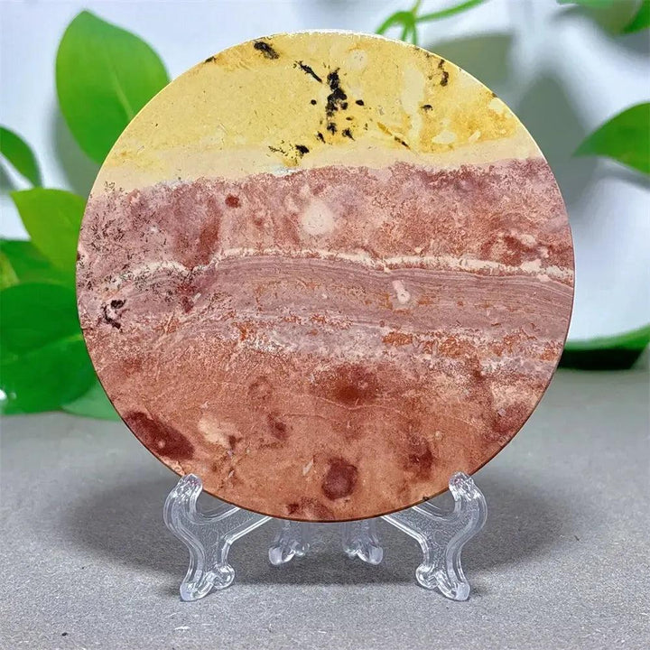 Round Picture Jasper crystal slice with desert landscape patterns in cream, ochre, and deep brown on a clear stand from Crystal Destiny.