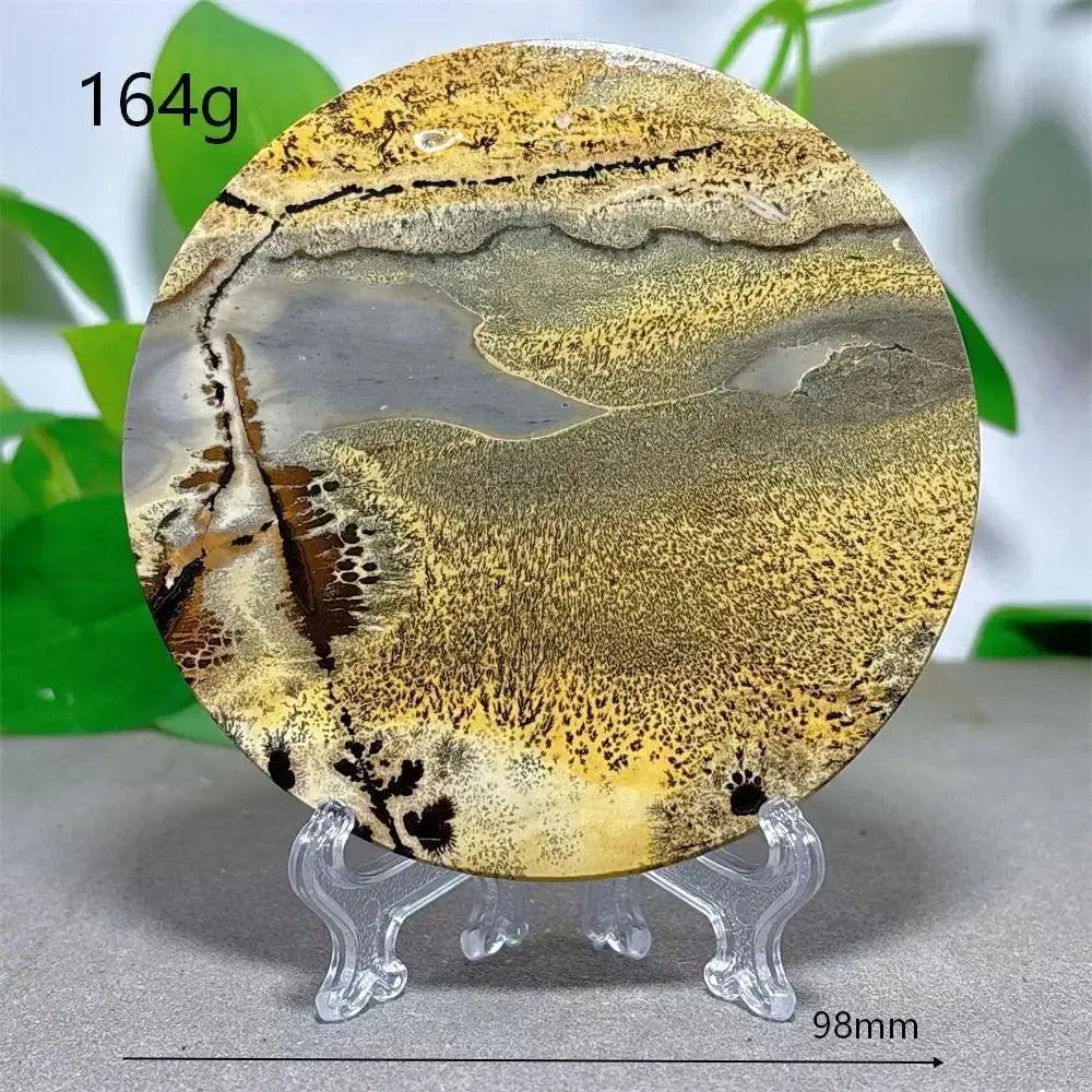 Round Picture Jasper crystal slice with desert landscape patterns in cream, ochre, and deep brown, on a clear stand from Crystal Destiny.