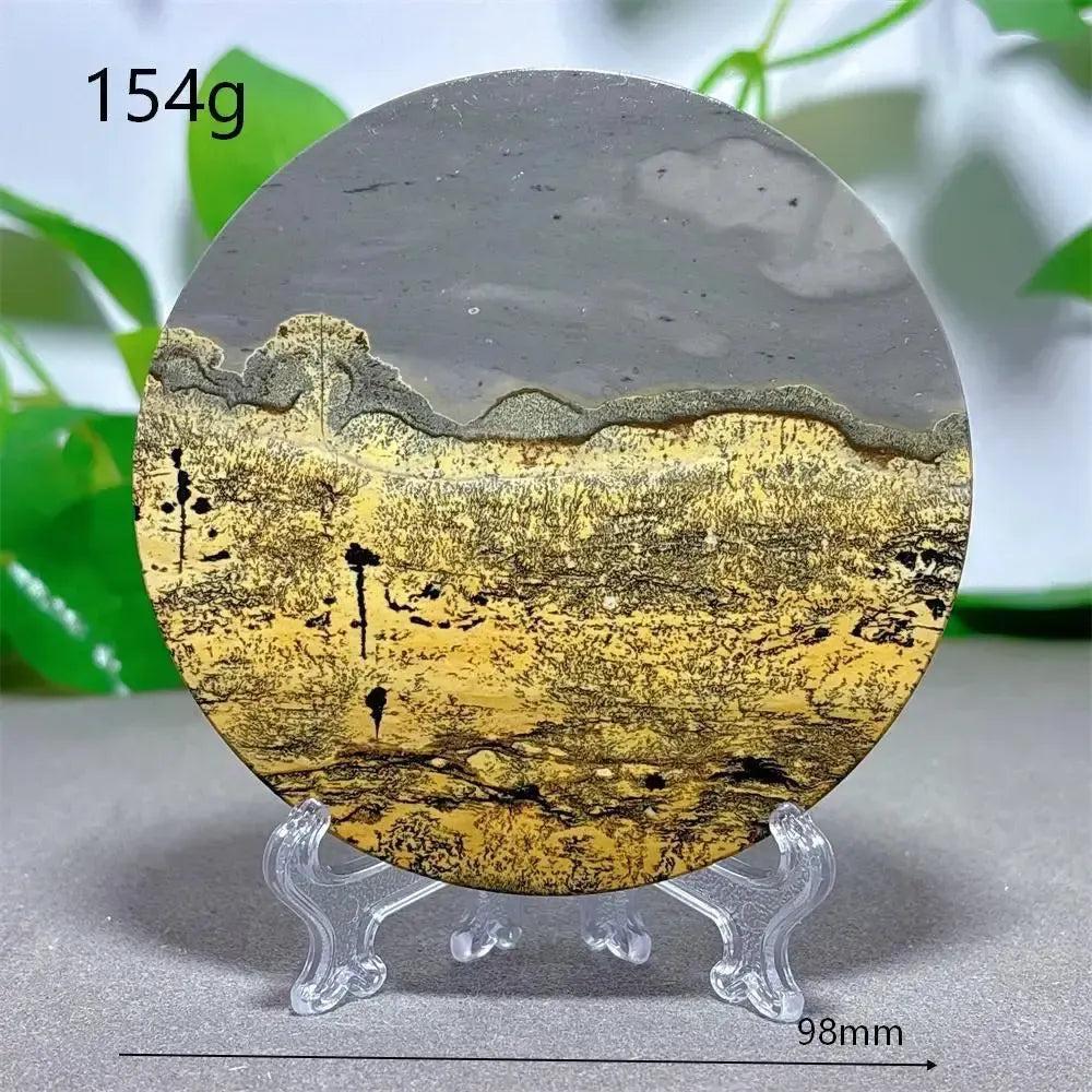 Round Picture Jasper crystal slice from Crystal Destiny, featuring earthy yellow, brown, and gray landscape patterns on a stand.