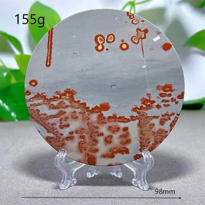 Round Picture Jasper crystal slice with red-brown patterns on a grey background, displayed on a clear stand from Crystal Destiny.