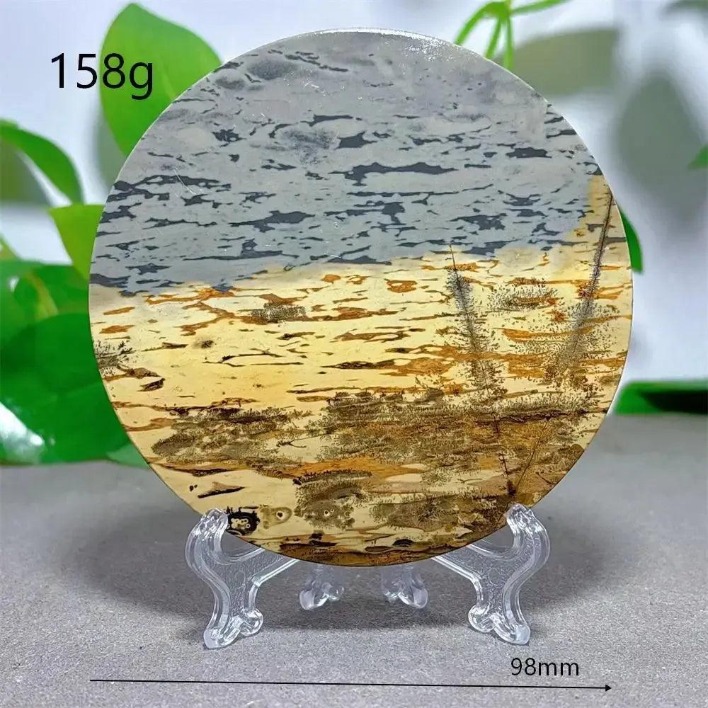 Round Picture Jasper crystal slice with desert landscape patterns, cream to deep brown hues, on a clear stand from Crystal Destiny.
