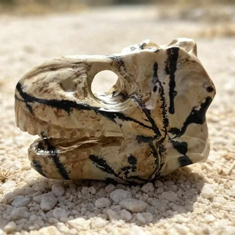 Hand-carved Picture Jasper dinosaur head with tan and brown landscape patterns for grounding and creative inspiration.
