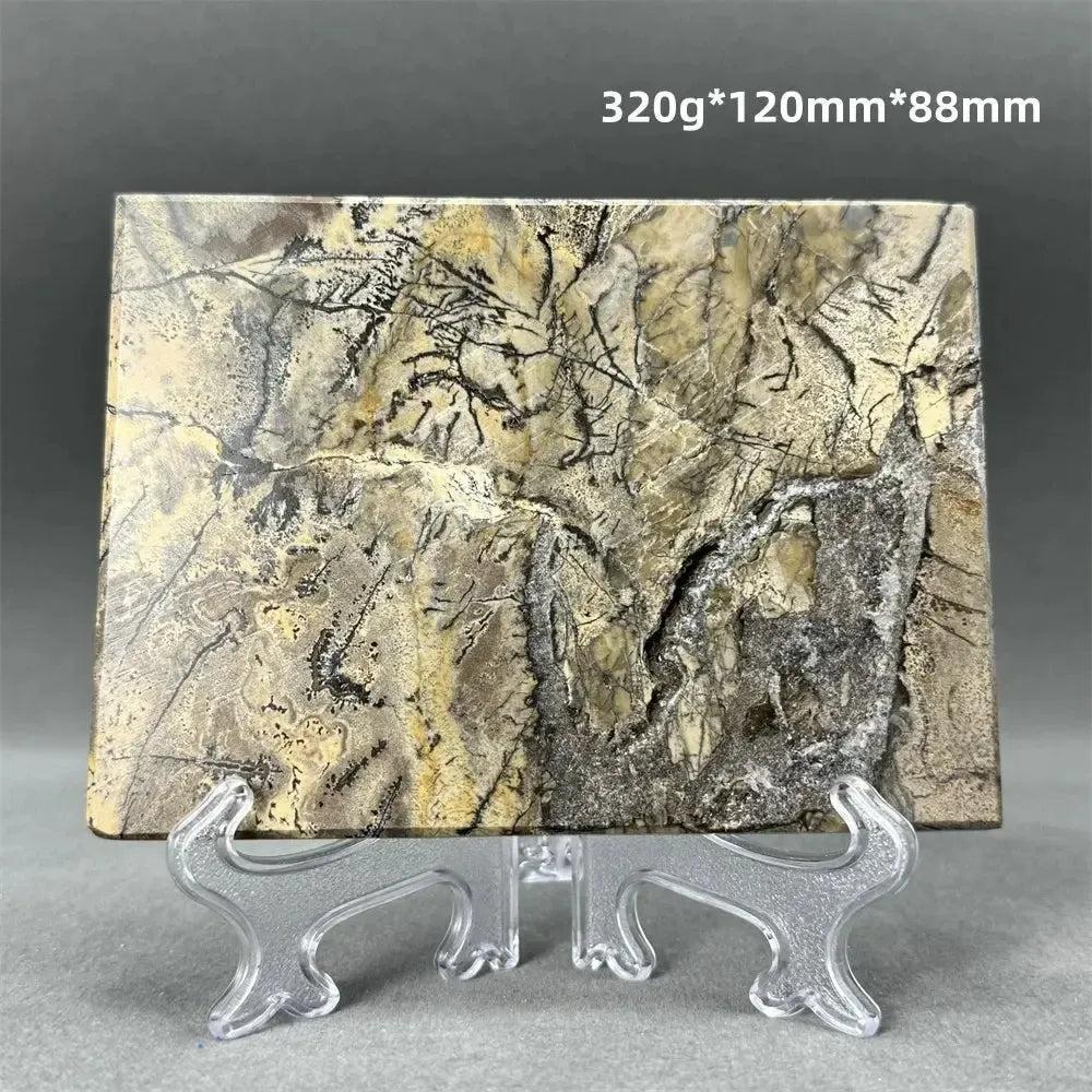 Polished Picture Jasper slice with natural landscape patterns in cream, sand, and ochre, on a clear stand from Crystal Destiny.