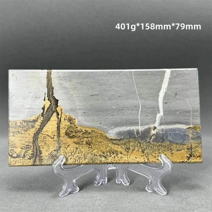 Polished Picture Jasper slice with natural landscape patterns in grey, gold, and brown, on a clear stand from Crystal Destiny.