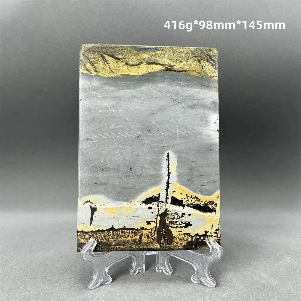Polished Picture Jasper slice with natural landscape patterns in grey, ochre, and brown, on a clear stand from Crystal Destiny.