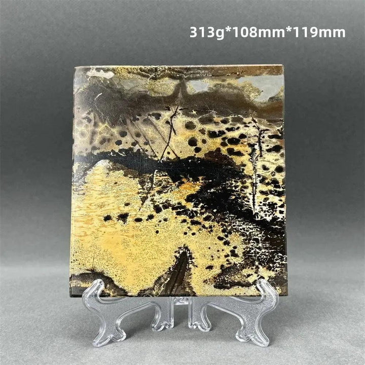 Polished Picture Jasper slice with unique landscape patterns in cream, sand, ochre, and brown, on a clear stand from Crystal Destiny.