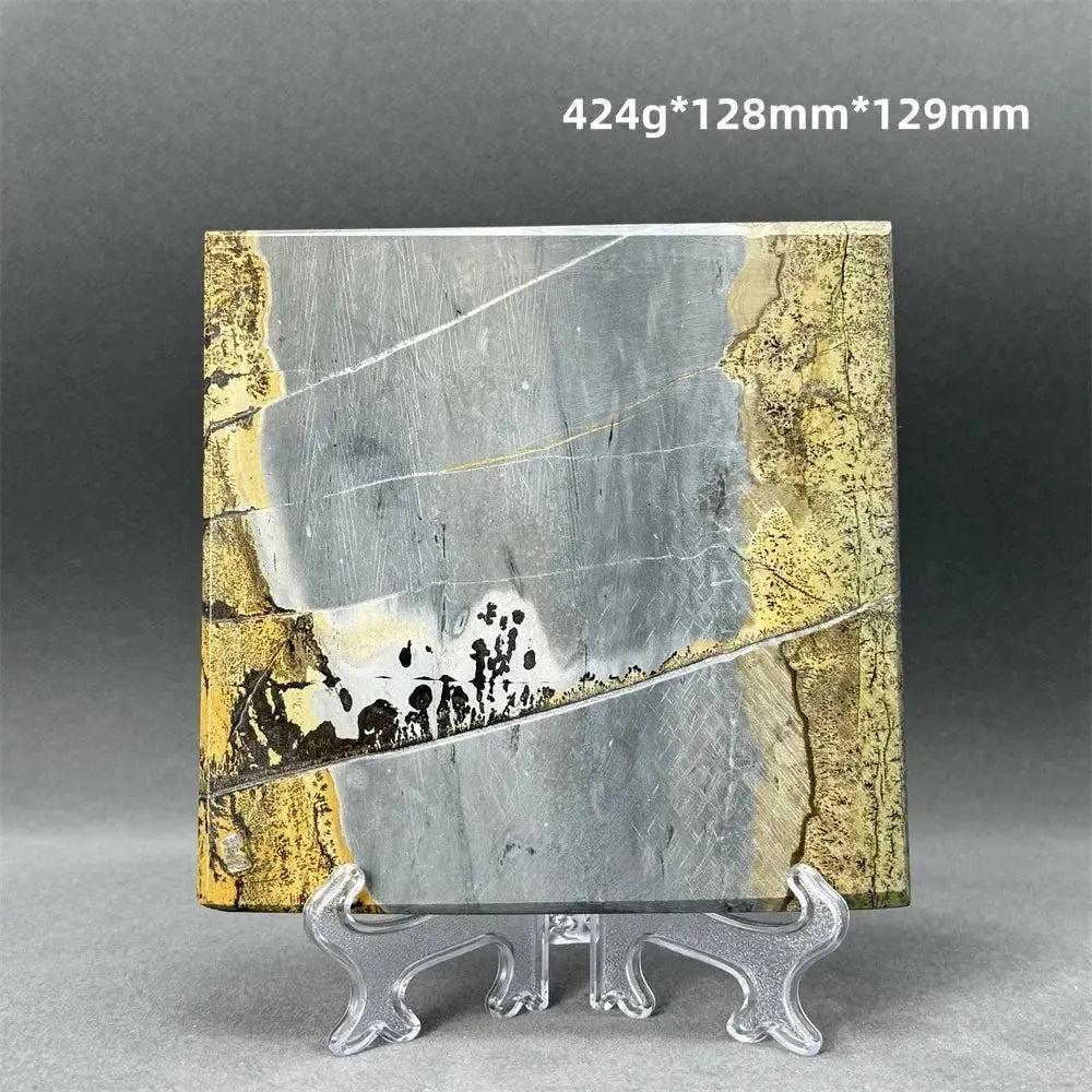 Polished Picture Jasper slice with natural landscape patterns in ochre, brown, and gray on a stand from Crystal Destiny.