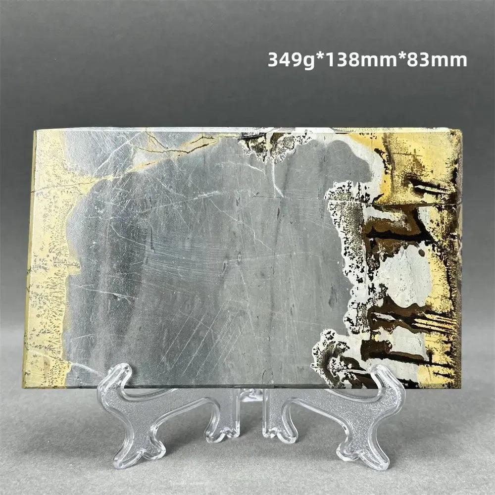 Polished Picture Jasper slice with unique landscape patterns in grey, gold, and brown on a clear stand from Crystal Destiny.