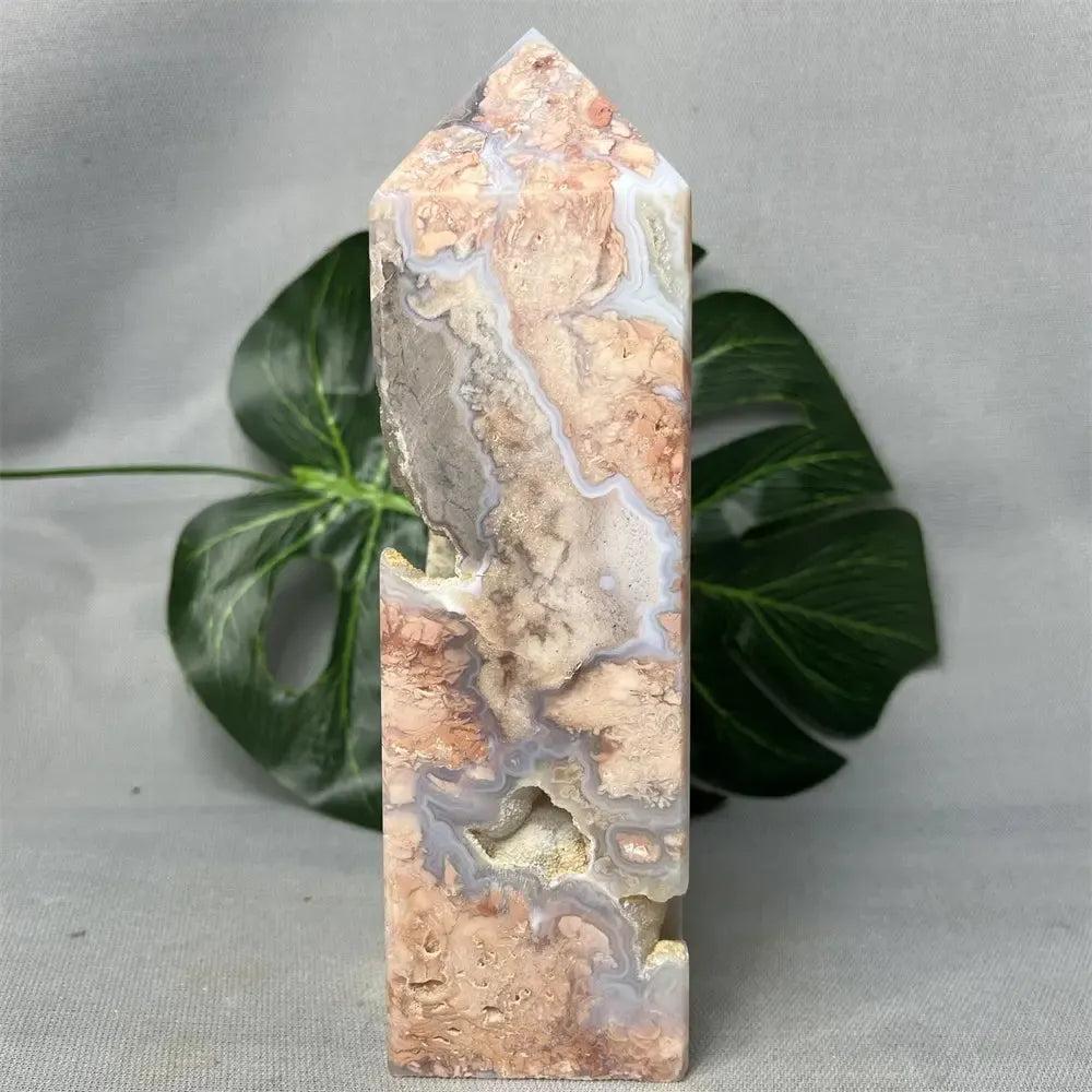 Pink Agate geode crystal tower from Crystal Destiny, featuring a polished exterior, raw druzy cave, and soft pink hues.
