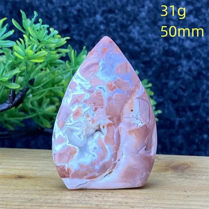 Hand-polished pink agate geode torch from Crystal Destiny, showcasing natural blush and cream banding for emotional balance.