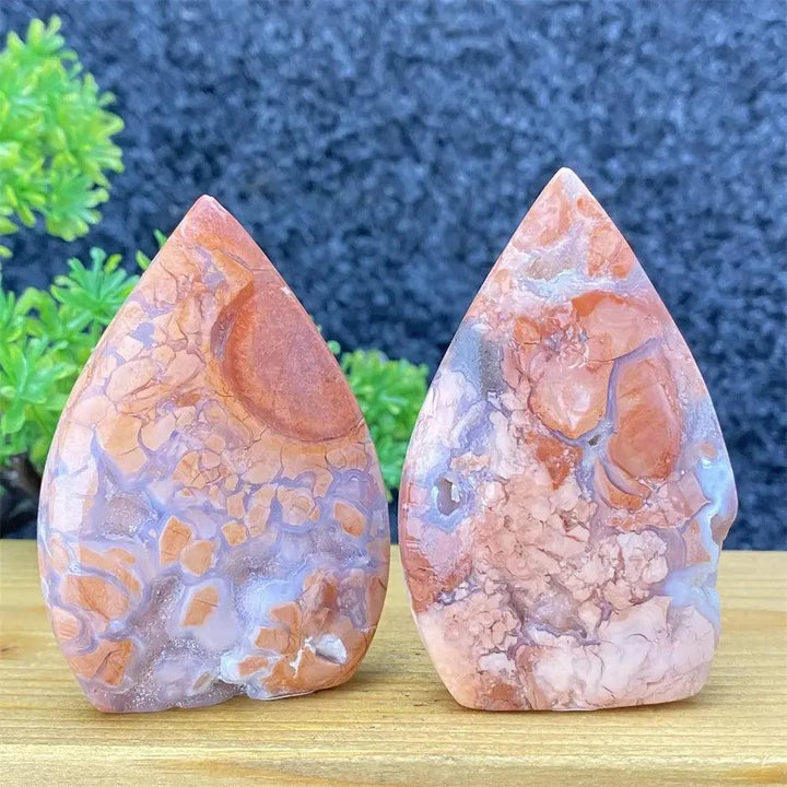 Two hand-polished pink agate geode torch specimens from Crystal Destiny, showcasing unique blush and cream banding.