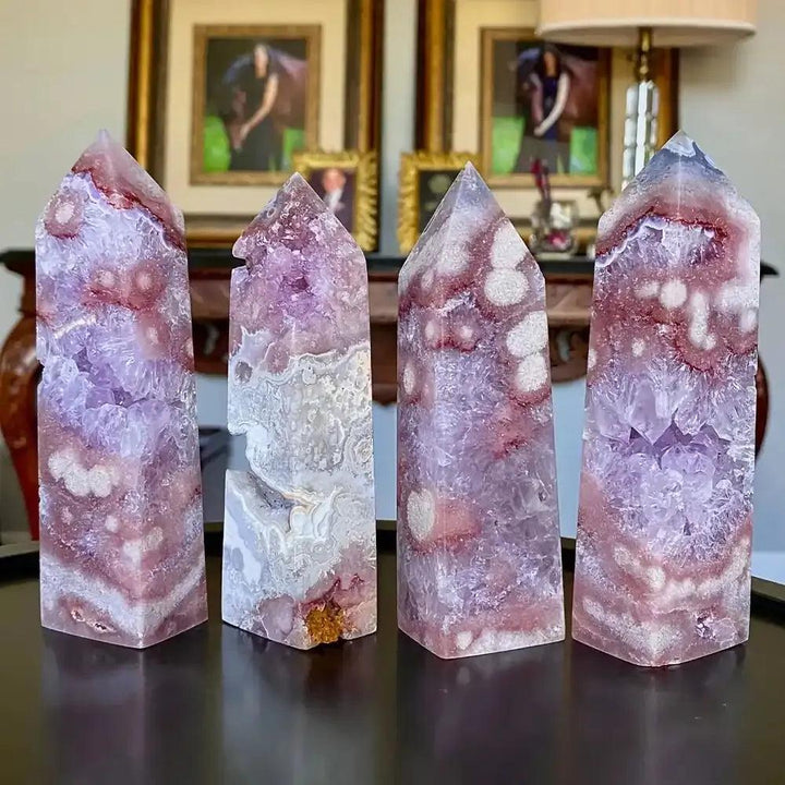 Hand-polished Pink Amethyst towers featuring soft lavender quartz, white banding, and faceted points for heart-centered peace.