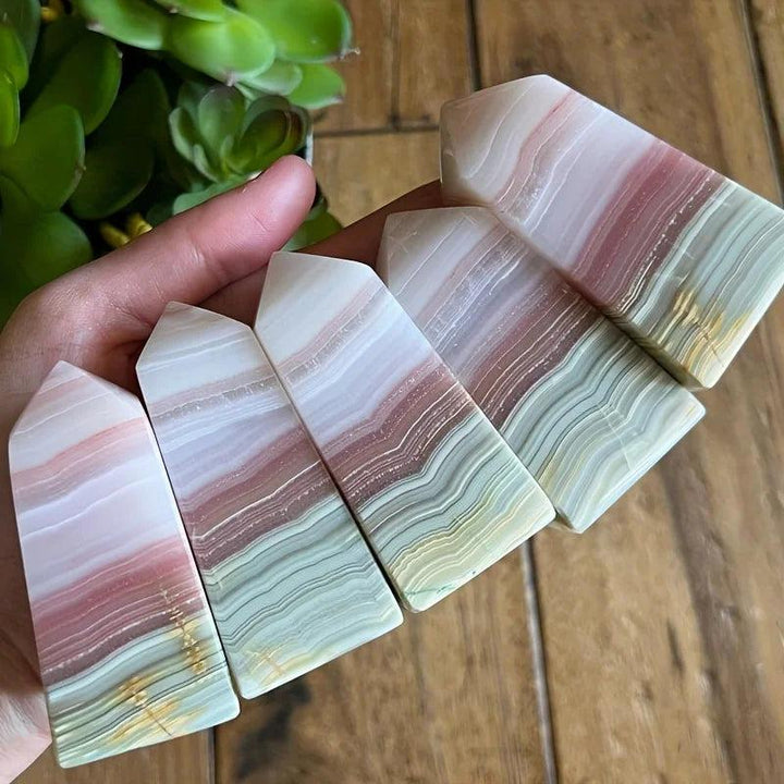 Pink Banded Calcite Crystal Towers with soothing pink, peach, and green layers for heart healing.