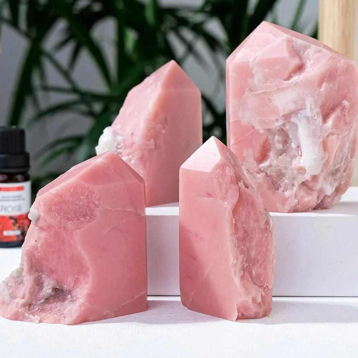 Polished bubblegum pink opal towers for heart chakra healing, featuring natural, irregular shapes and soft pink hues.