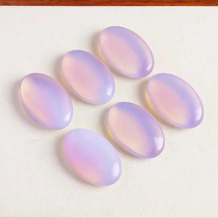 Smooth, milky pink opalite palm stones with a glassy finish, perfect for Heart chakra meditation and self-love.