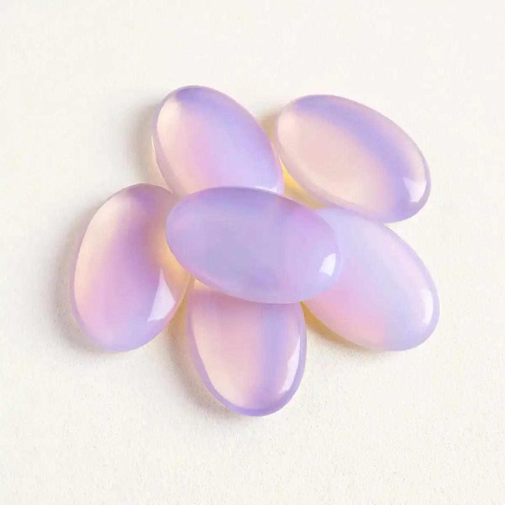 Smooth, milky pink opalite palm stones with a glassy finish, perfect for Heart chakra meditation and calming self-love.