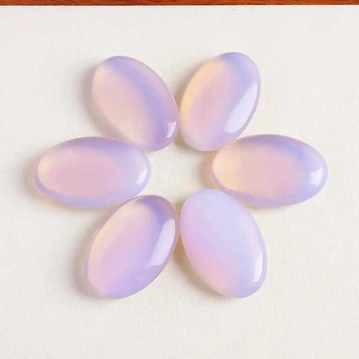 Smooth, milky pink opalite palm stones with a glassy glow, perfect for Heart chakra meditation and calming self-love.