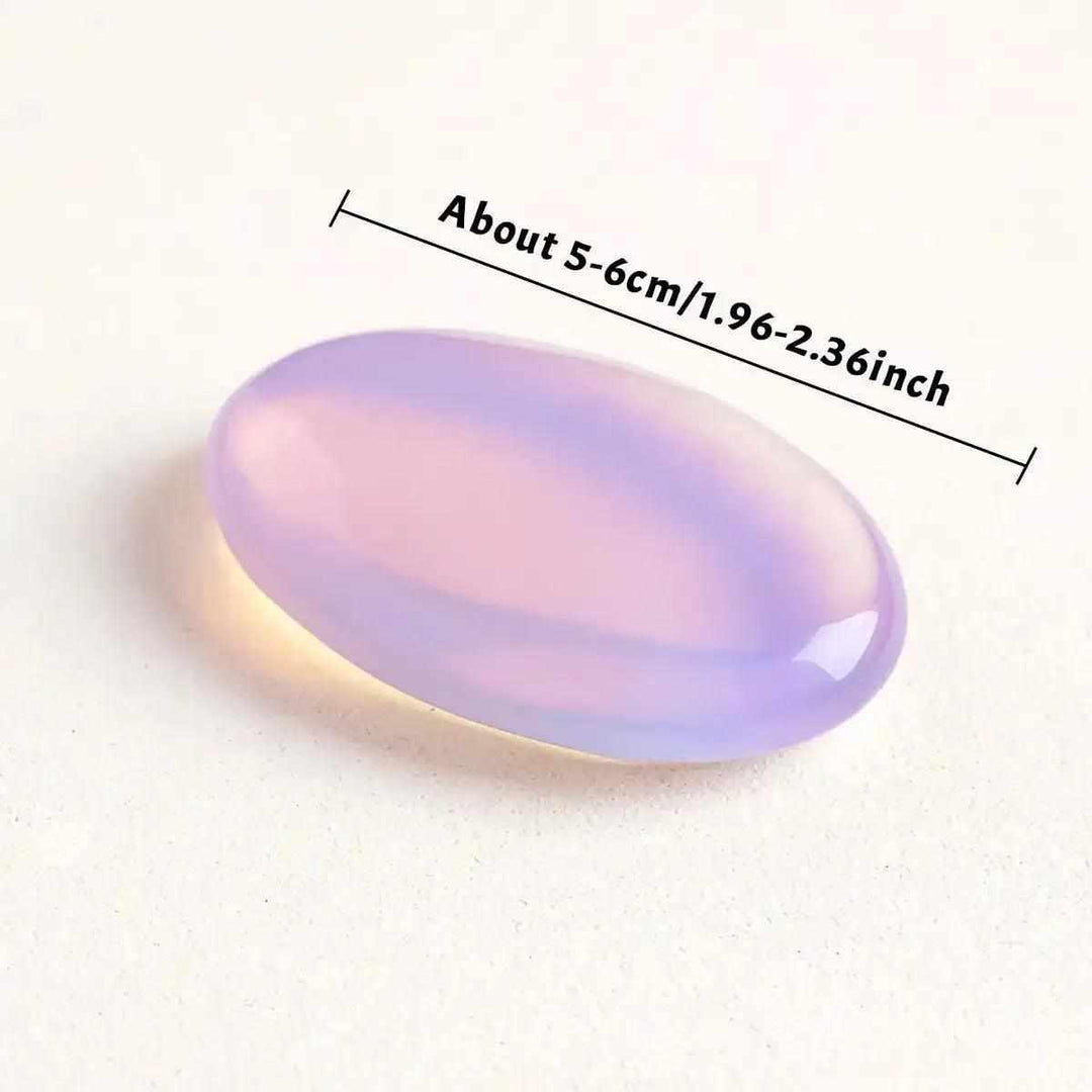 Smooth, milky pink opalite palm stone with a glassy finish, perfect for Heart chakra meditation and calming self-love.