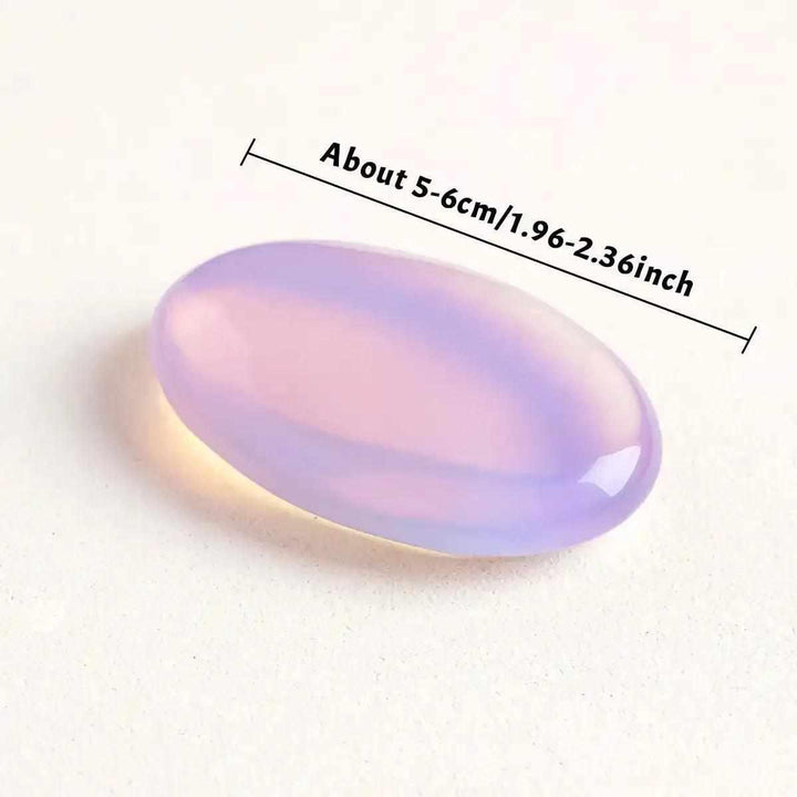 Smooth, milky pink opalite palm stone with a glassy finish, perfect for Heart chakra meditation and calming self-love.