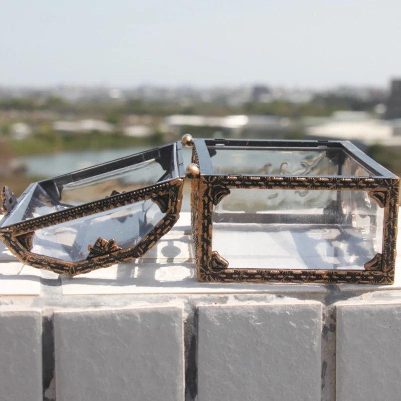 Clear plastic pirate treasure box with ornate gold trim and a hinged lid, perfect for displaying your favorite crystals.