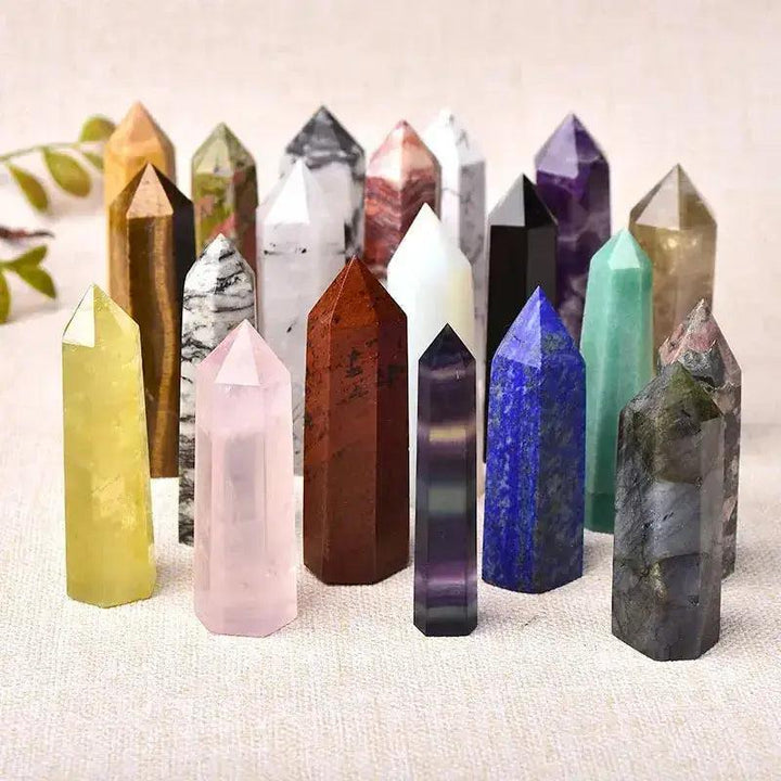 Polished crystal towers in diverse materials like rose quartz, amethyst, and lapis lazuli, ideal for energy work and decor.