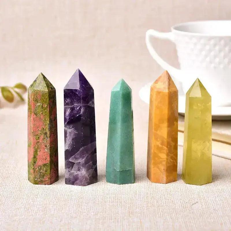 Five polished crystal towers: red-green Unakite, purple Amethyst, green Aventurine, orange Calcite, and yellow Citrine.