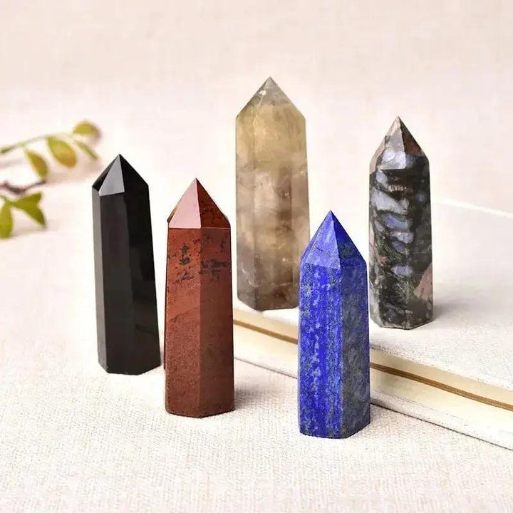 Polished crystal towers in black obsidian, red jasper, citrine, lapis lazuli, and kambaba jasper for energy work.
