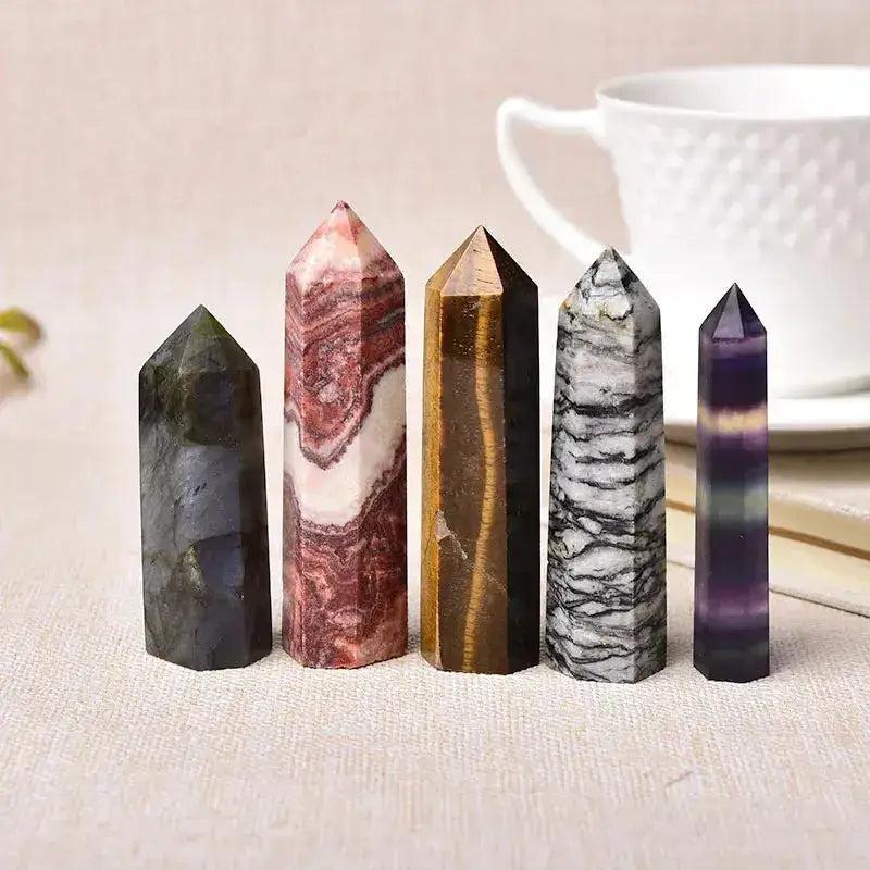 Assorted natural crystal towers in various polished stones like Tiger's Eye and Fluorite, ideal for energy work and decor.