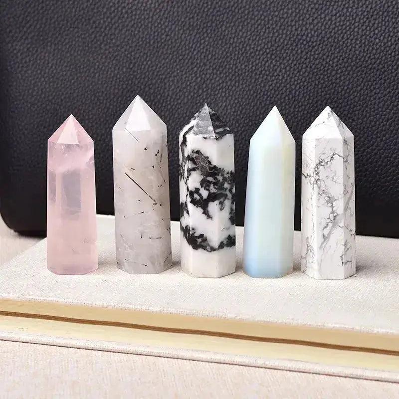 Polished crystal towers in rose quartz, tourmalinated quartz, tree agate, blue calcite, and white marble for energy work.