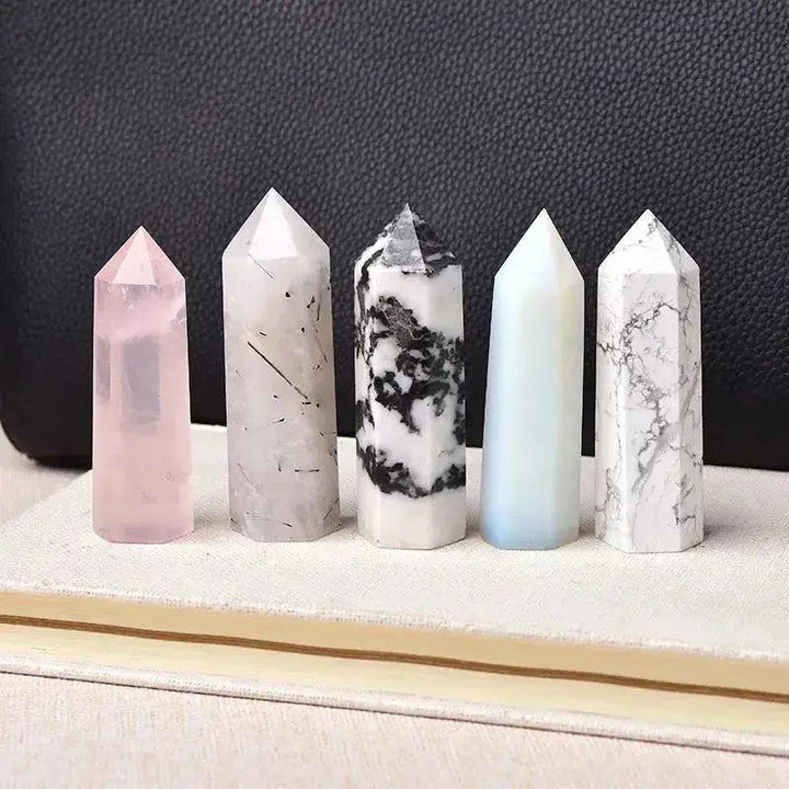 Polished crystal towers in rose quartz, tourmalinated quartz, tree agate, blue calcite, and white marble for energy work.