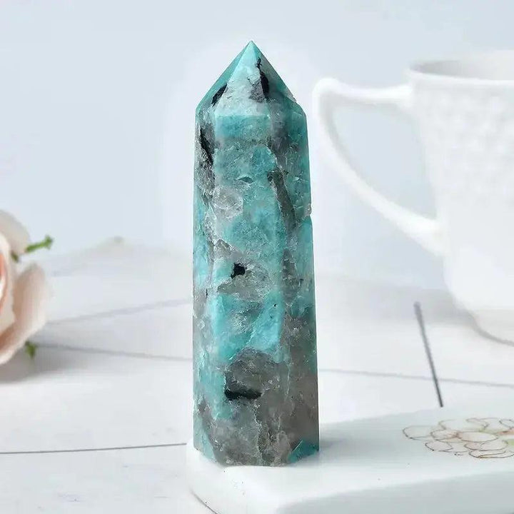 Polished Amazonite Crystal Tower with vibrant blue-green hues and black inclusions, perfect for energy work and décor.