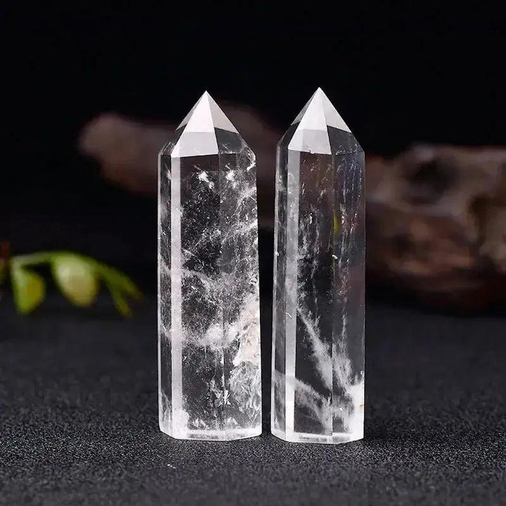 Two clear quartz crystal towers, hand-polished, showcasing natural clarity and unique internal patterns for energy work.