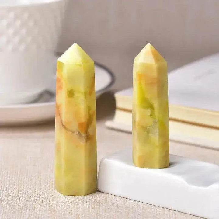 Two polished yellow and orange crystal towers, ideal for energy work, chakra balancing, and home décor.
