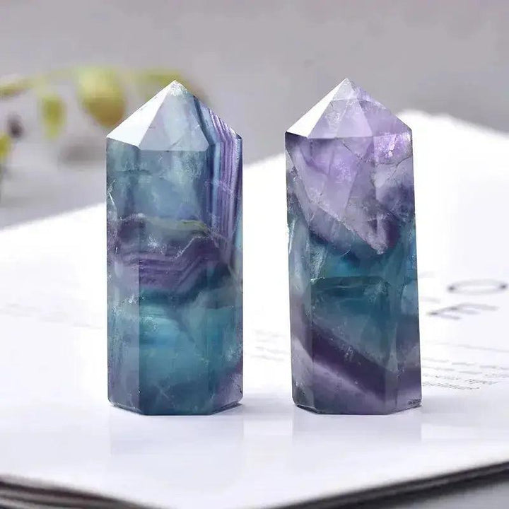Two polished Fluorite Crystal Towers, showcasing vibrant purple and teal hues, perfect for energy work and décor.