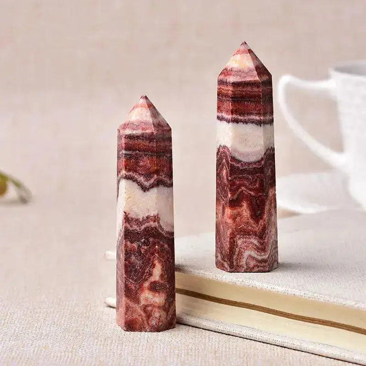 Two polished red and white striped crystal towers, ideal for energy work and home décor.