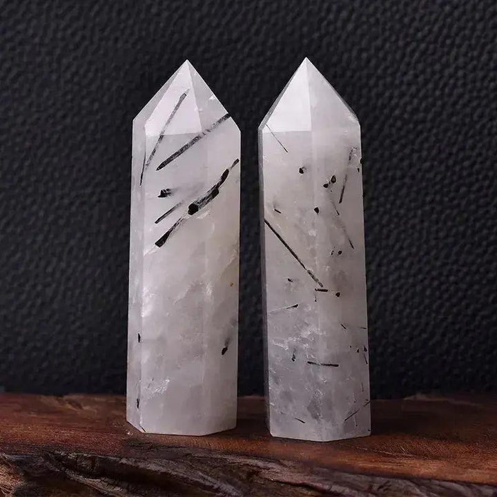 Two polished clear quartz crystal towers with black tourmaline inclusions, ideal for energy work and décor.