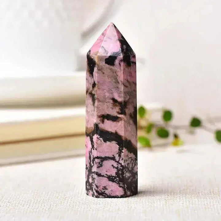 Polished Rhodonite Crystal Tower with vibrant pink and black patterns, ideal for chakra balancing and sacred spaces.