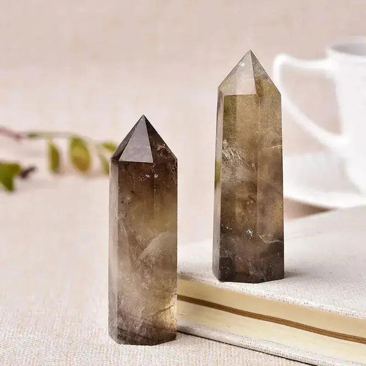 Two polished smoky quartz crystal towers, showcasing their unique brown hues and natural crystalline structure.