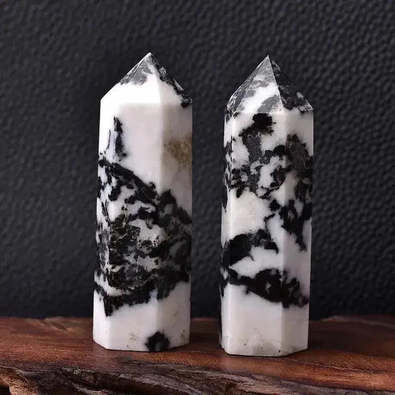 Two polished black and white Zebra Jasper crystal towers, ideal for energy work and home décor.